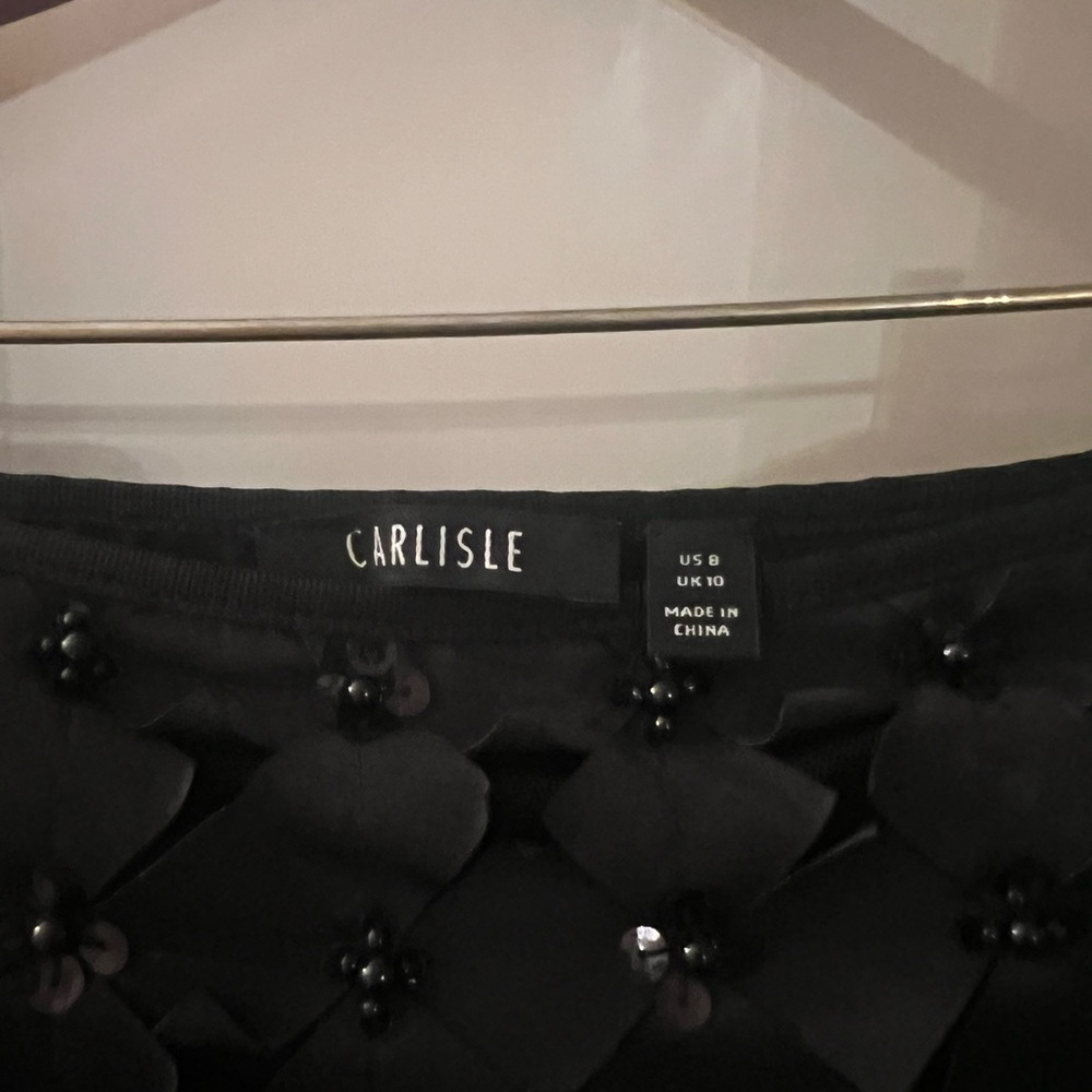 Barely worn black vcarlusle cocktailail skirt. Knee length. Ribbon and beaded.